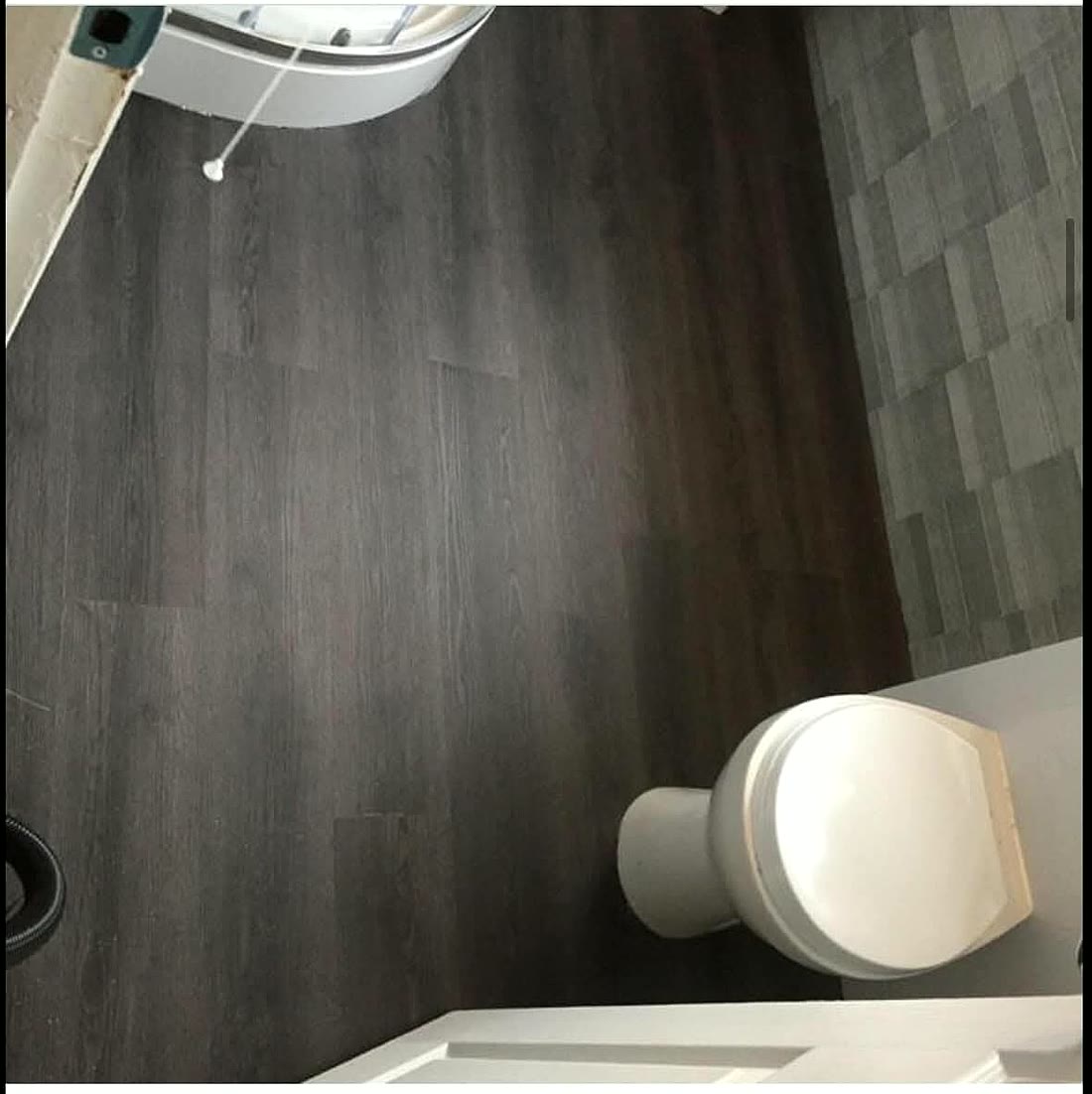 Dark wood effect vinyl in a small toilet